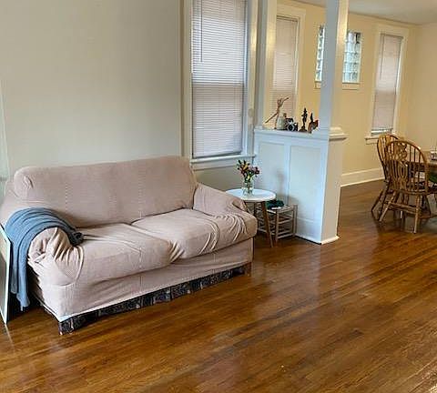 Inviting Living Room Natural Light & Hardwood Floors Ceiling Fan