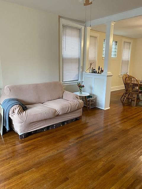 Inviting Living Room Natural Light & Hardwood Floors Ceiling Fan