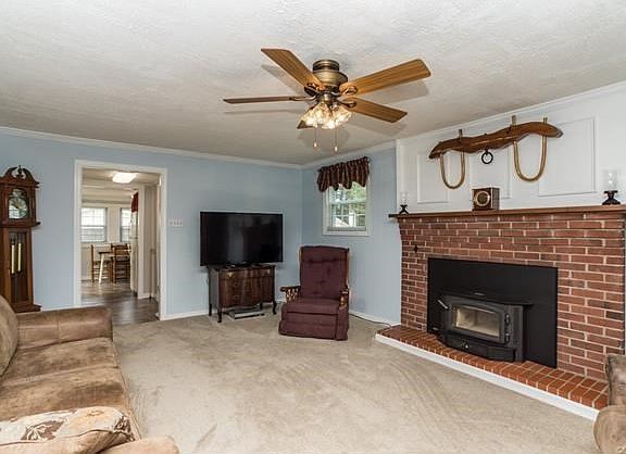Family room w/brick fireplace and wood-burning insert.