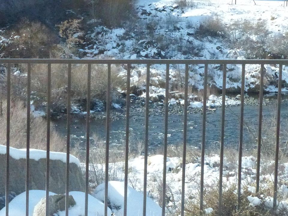 River flowing in back of house.
