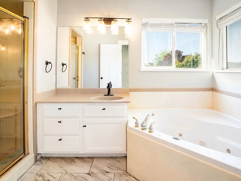 Master bathroom with dual vanity, dual shower heads, and jacuzzi tub