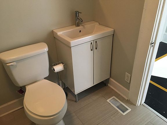 Corner of bathroom with IKEA sink.