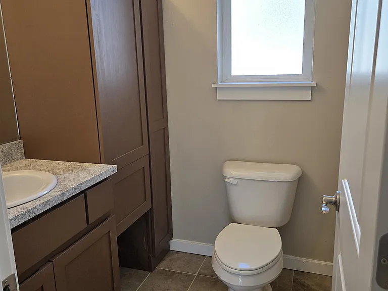 Main floor half bathroom with added storage.