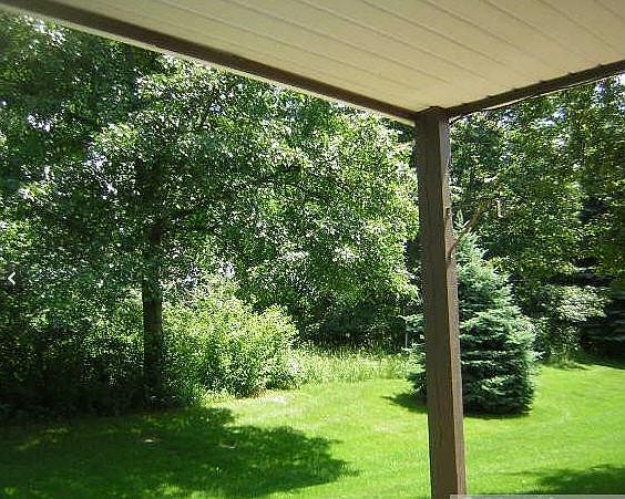 Backyard and patio under three season porch