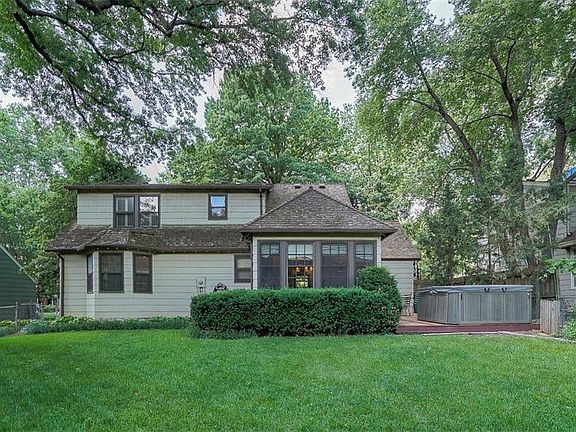 Large, flat back yard with lots of trees.