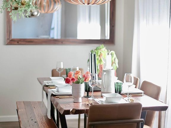 Dining room off the kitchen and open to the living room with sliding door to patio