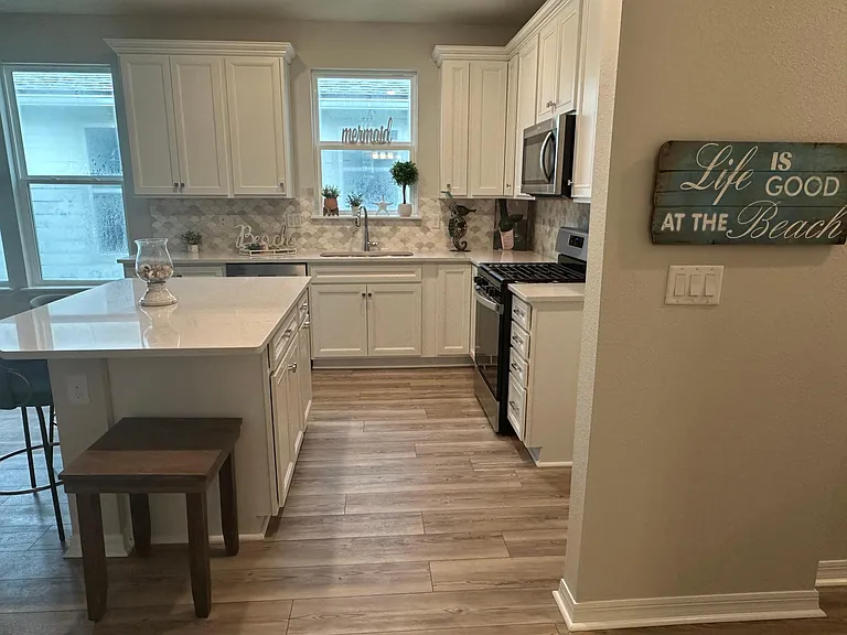 Kitchen w/ quartz island and designer backsplash
