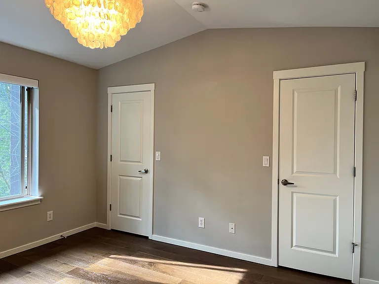 large walk in closet with two doors