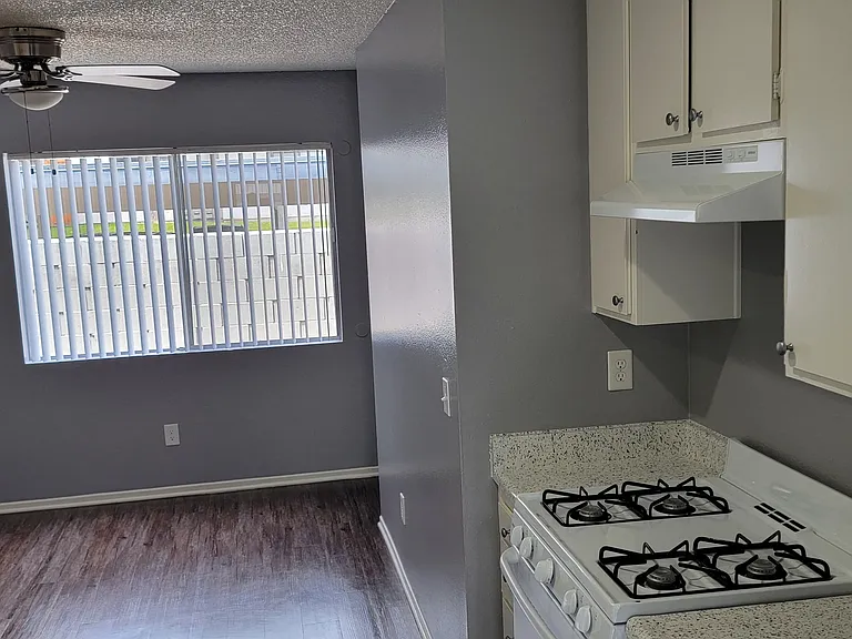 Kitchen view of dining room at Grand Oaks Apartments in Lake Elsinore, California.