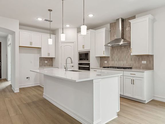Spacious kitchen with oversized island real home pictured