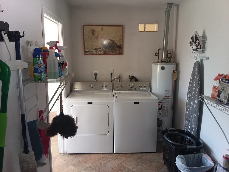 Laundry room area. Storage cabinets are also located in there.
