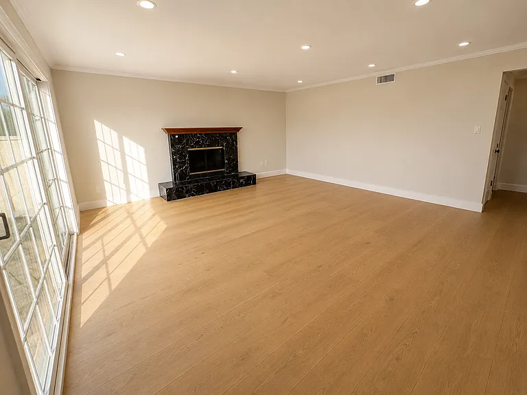Large and bright living room - Brand new laminate wood flooring and fresh paint throughout house.