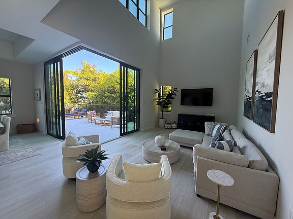 Living room with sliding glass doors to outdoor lanai and living area.