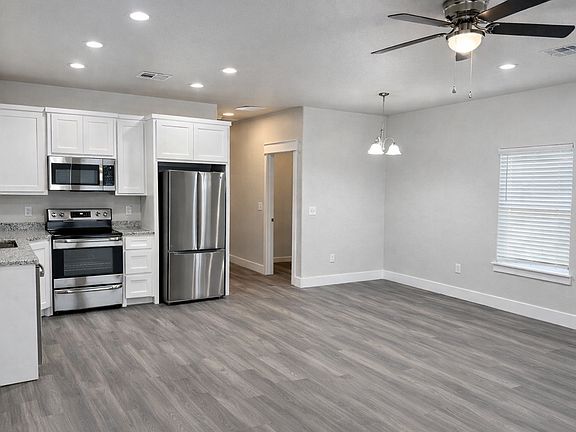 Modern kitchen featuring granite countertops and stainless steel appliances.