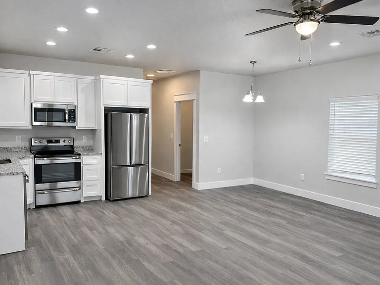 Modern kitchen featuring granite countertops and stainless steel appliances.