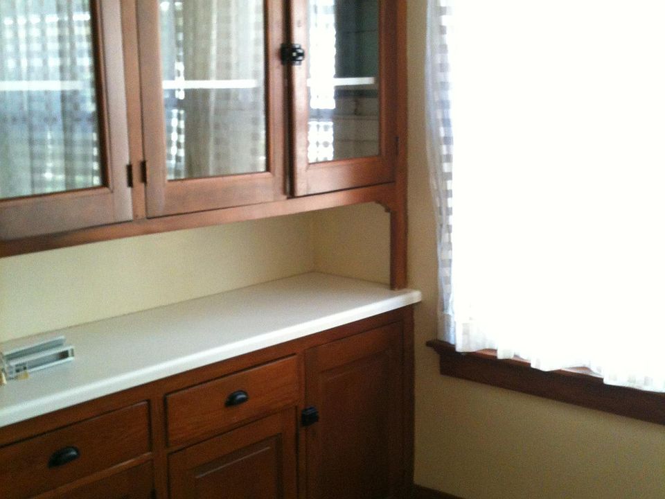 Kitchen includes many cabinets.