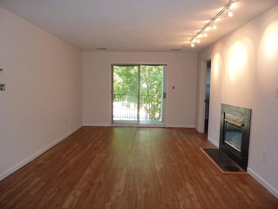 Living Room with Slider to Balcony and Gas Fireplace