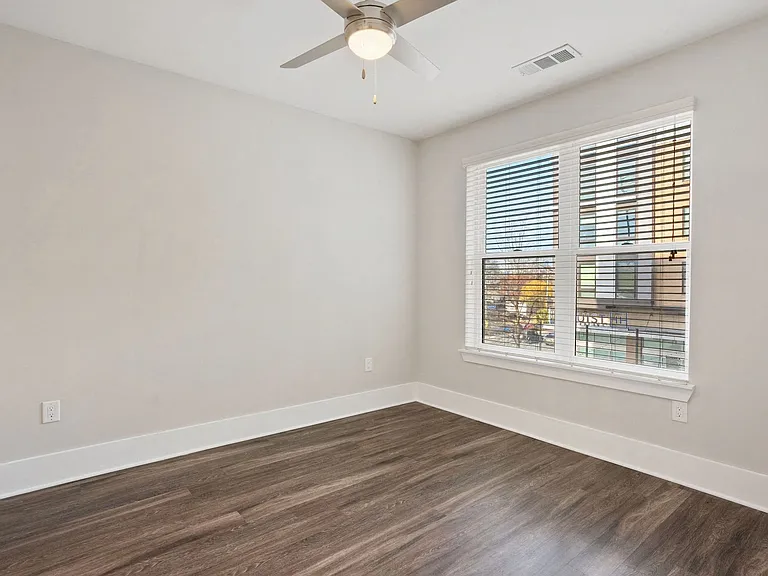 Spacious bedrooms with large windows and luxury vinyl tile flooring.