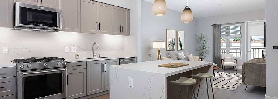 Phase II Signature Collection Kitchen and dining area with grey cabinetry, white marble countertops and backsplash, upgraded stainless steel appliances, and hard surface flooring