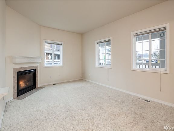 Another view of the gas fireplace, and the nice natural lighting provided by the multiple windows, all with levelor blinds.