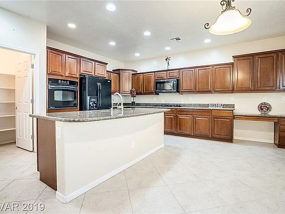 Fabulous chef's dream kitchen! Granite countertop, BI oven, 5 burner cooktop stove & lots of pull-outs! Notice extended office d