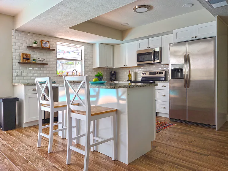 Newly Renovated Kitchen with Granite Countertops and Stainless Steel Appliances. Stocked with Pots, Pans, Dishes & Utensils for Cooking.