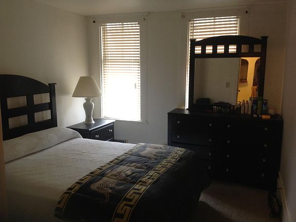 Front Bedroom, set before window replacements, showing queen-size bed