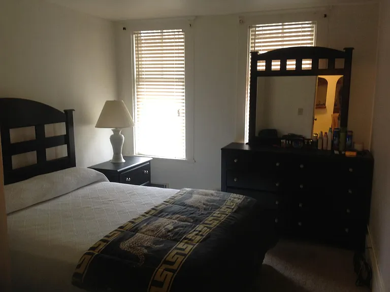 Front Bedroom, set before window replacements, showing queen-size bed