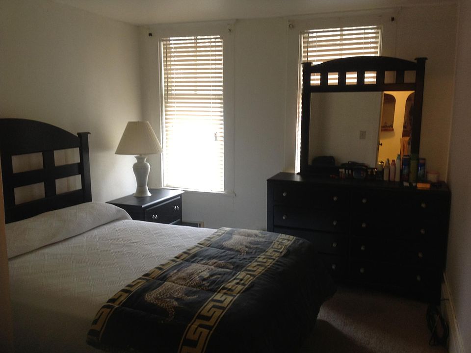 Front Bedroom, set before window replacements, showing queen-size bed