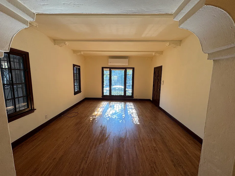 View of living room from the dining room. Large picture window. Decorative arches.
