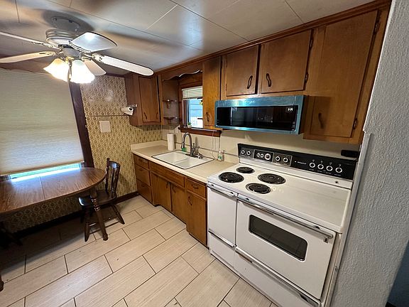 Kitchen with Appliances - New Fridge, Oversized Electric Stove and new over the range low-profile built-in 
microwave