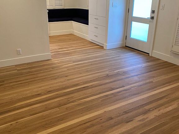 A view of the light & bright entry, with recently refinished white oak hardwood floors.