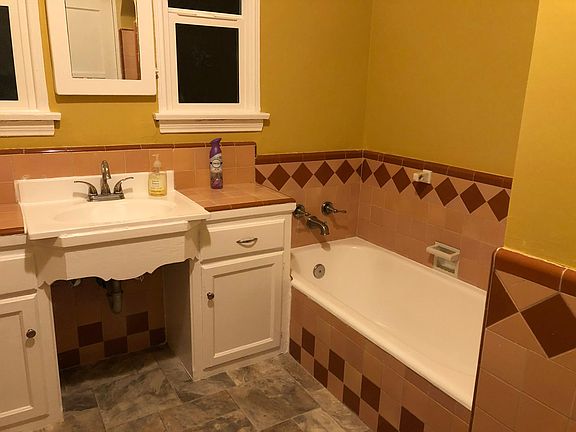 Hall way bathroom with full tub and separate shower.