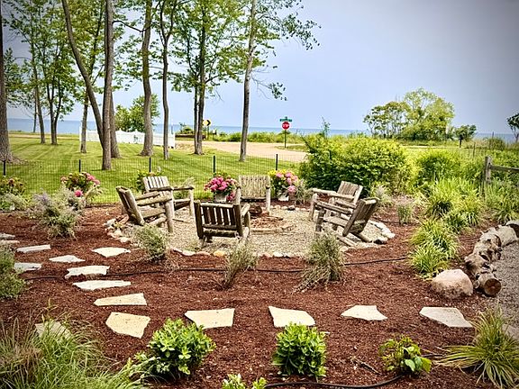 Relax under string lights with lake views, a fire pit, and open space_perfect for unforgettable evenings and outdoor entertaining.