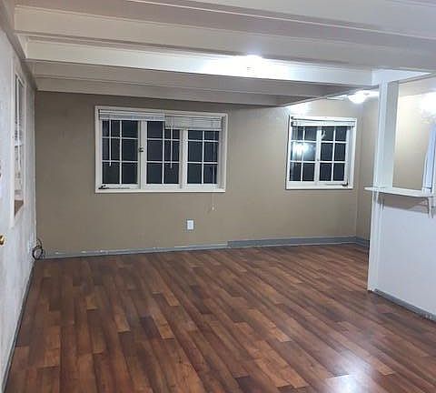 standing in front corner of the living room looking across