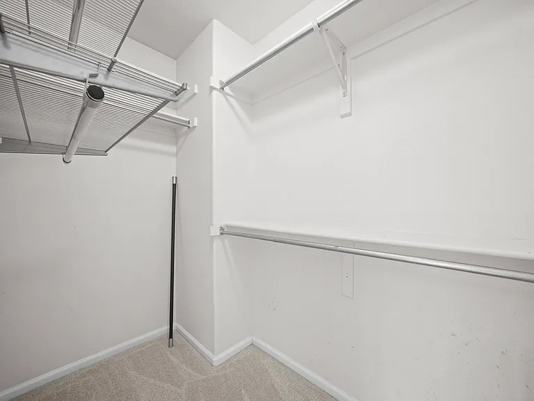 Primary bedroom walk in closet.