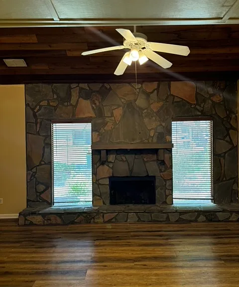 Living room with fireplace. Double windows looking into back garden.