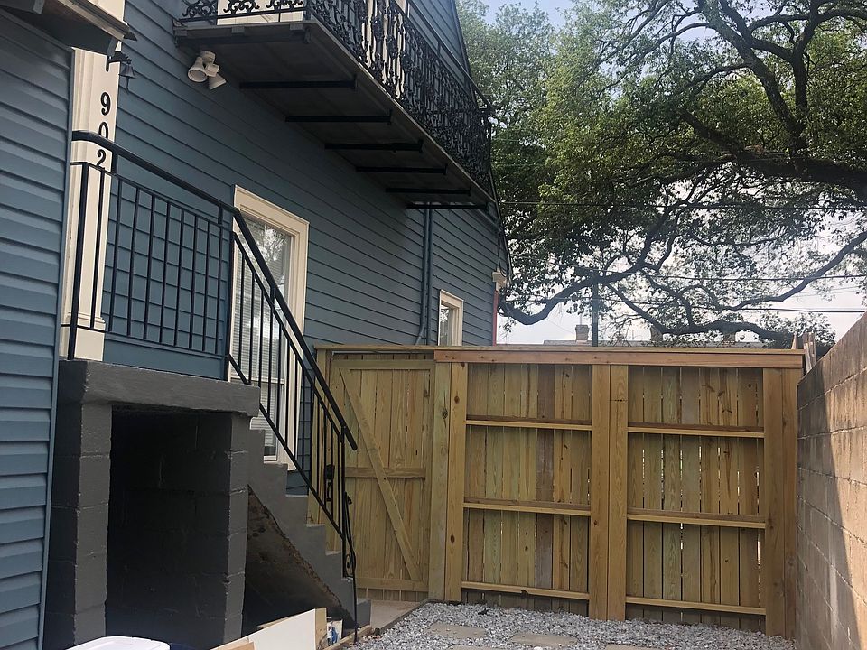 Gated courtyard. Stairs up to the apartment and balcony off bedrooms. Driveway is behind that fence/gate.