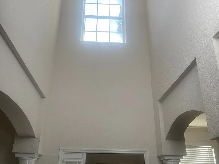 58 - High stairwell ceiling with upper-level window for daylight.