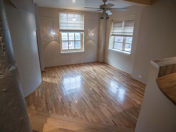 Look down into the living room with oak floor