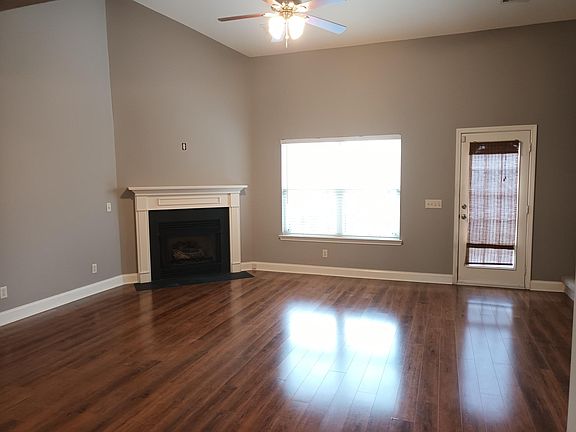 Twenty foot ceilings in great room with gas fireplace and fenced patio in back.