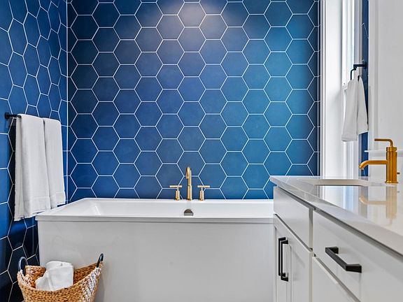 Luxe Primary Bath Features Free-Standing Tub and Double Vanity