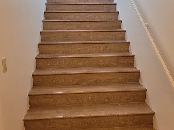 Stairs from entry to upper level, there is a entry way closet on ground floor door