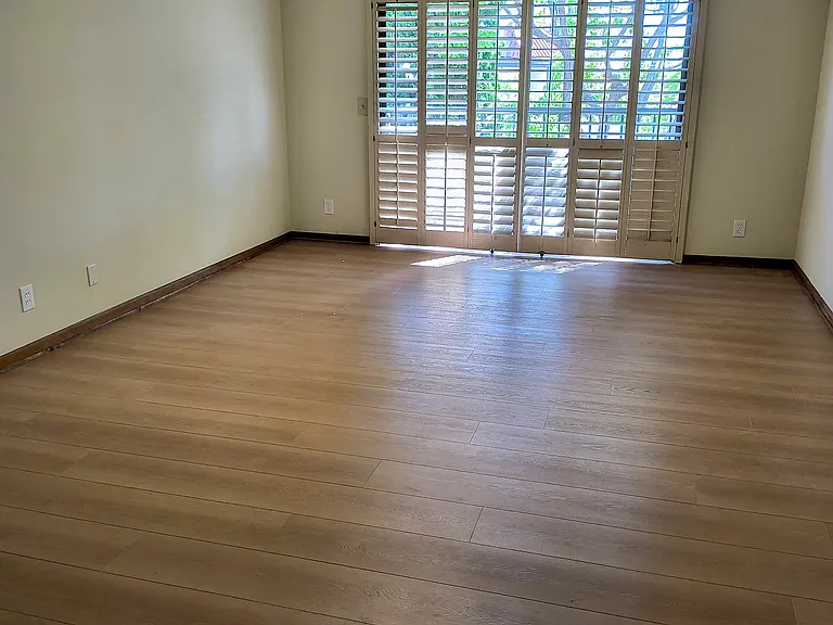 vacant primary bedroom with new floors