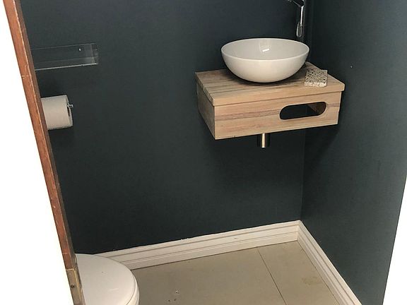 Small one-half bath off kitchen. Ver accessible for guest