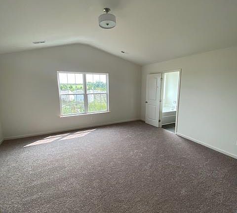Master bedroom with vaulted ceiling