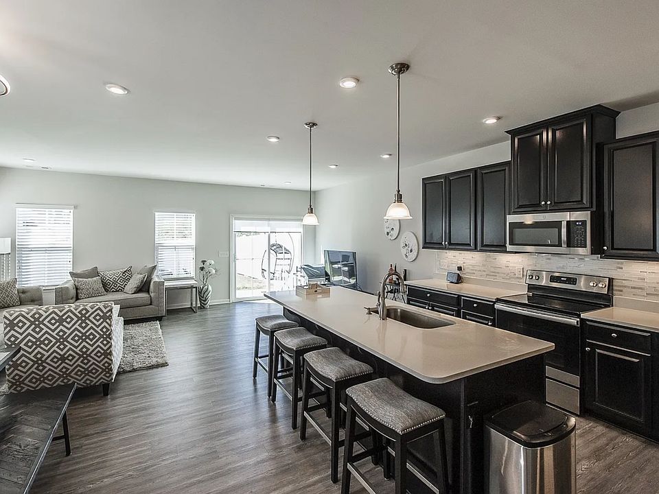 Open-concept living, dining, and kitchen with abundant natural light