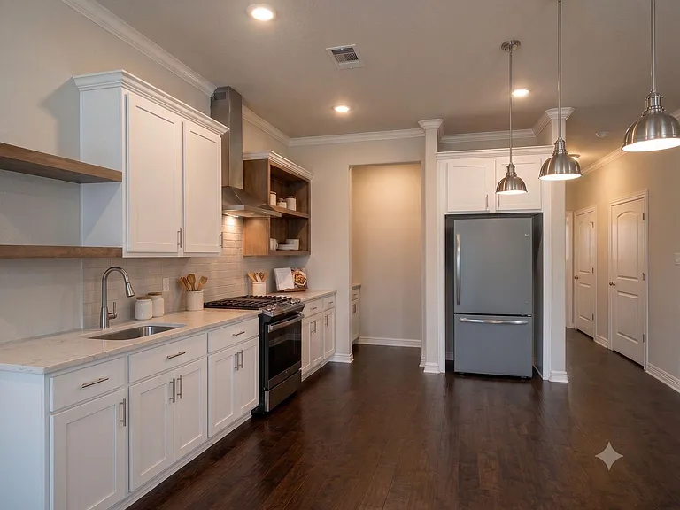 Spacious kitchen with shaker cabinetry, stone-look counters, gas range, subway-tile backsplash, and pendant lighting.