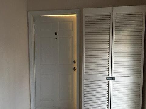 Door to apt from shared foyer with storage locker