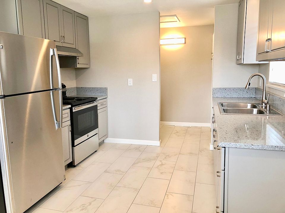 GE Stainless Steel Appliance & Porcelain Tile Floors.